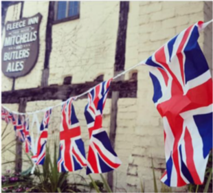 A photo of a string of Union Jack flags hanging up outside The Fleece Inn Bretforton