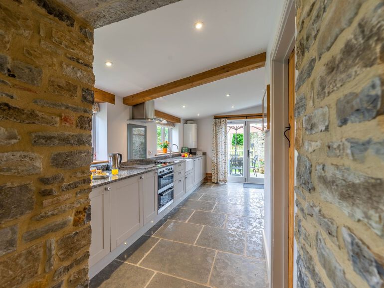 A photo of a kitchen in a converted barn holiday let in Bretforton