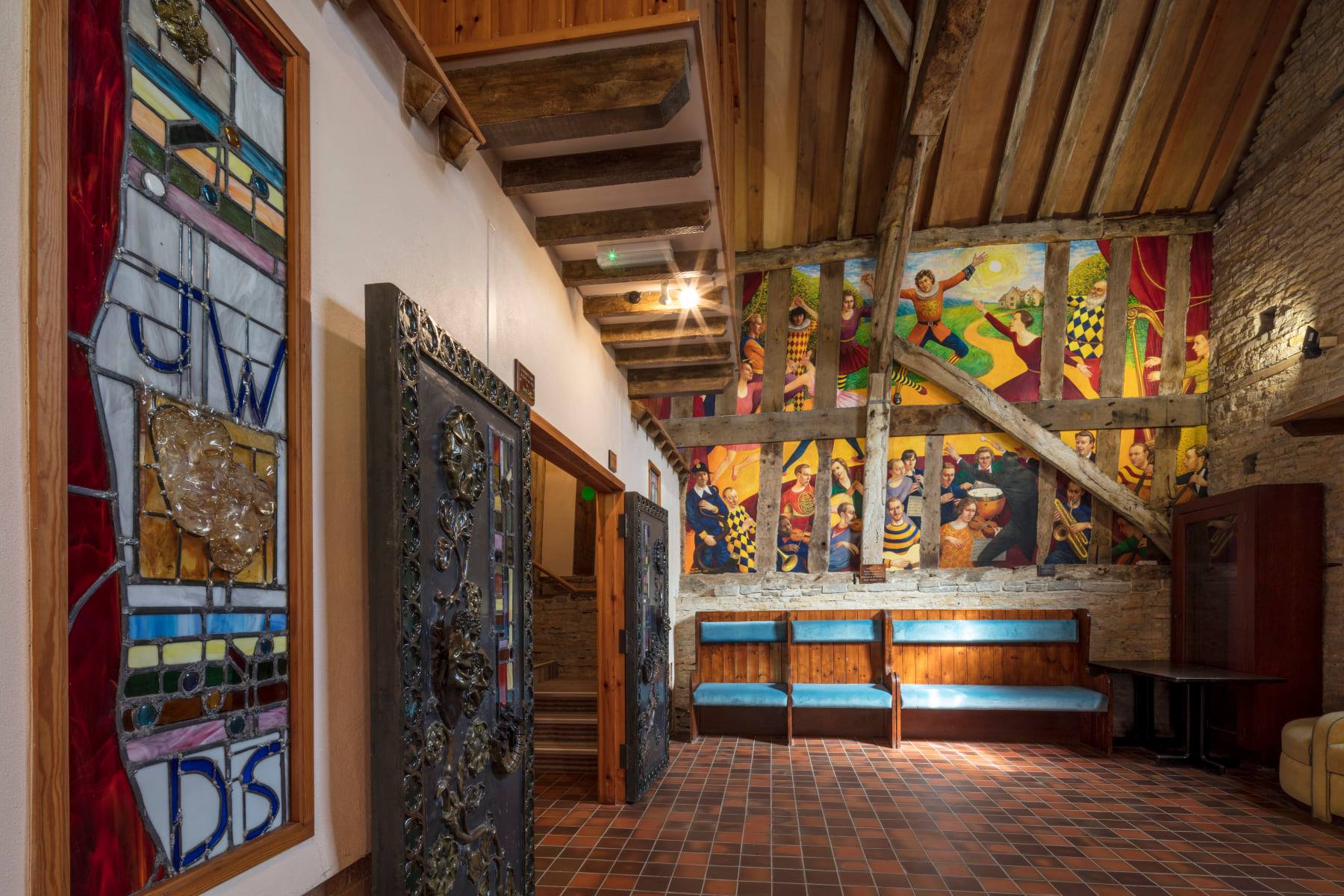 A photo of murals and stained glass at Bretforton Theatrebarn