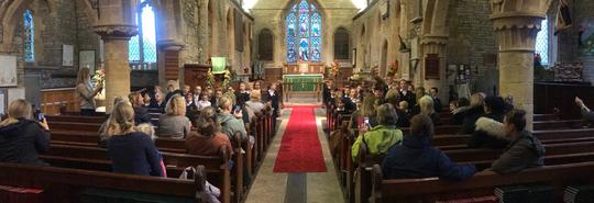 Bretforton Village School pupil singing to the congregation inside St Leonard's church
