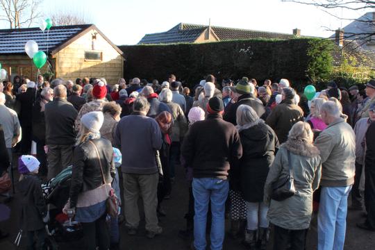 A photo of a large crowd listening to speeches at the opening of Bretforton Community Shop