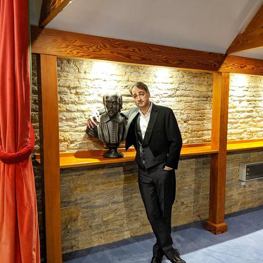 A photo of Alastair McGowan posing for a photo after performing at Bretforton Theatrebarn